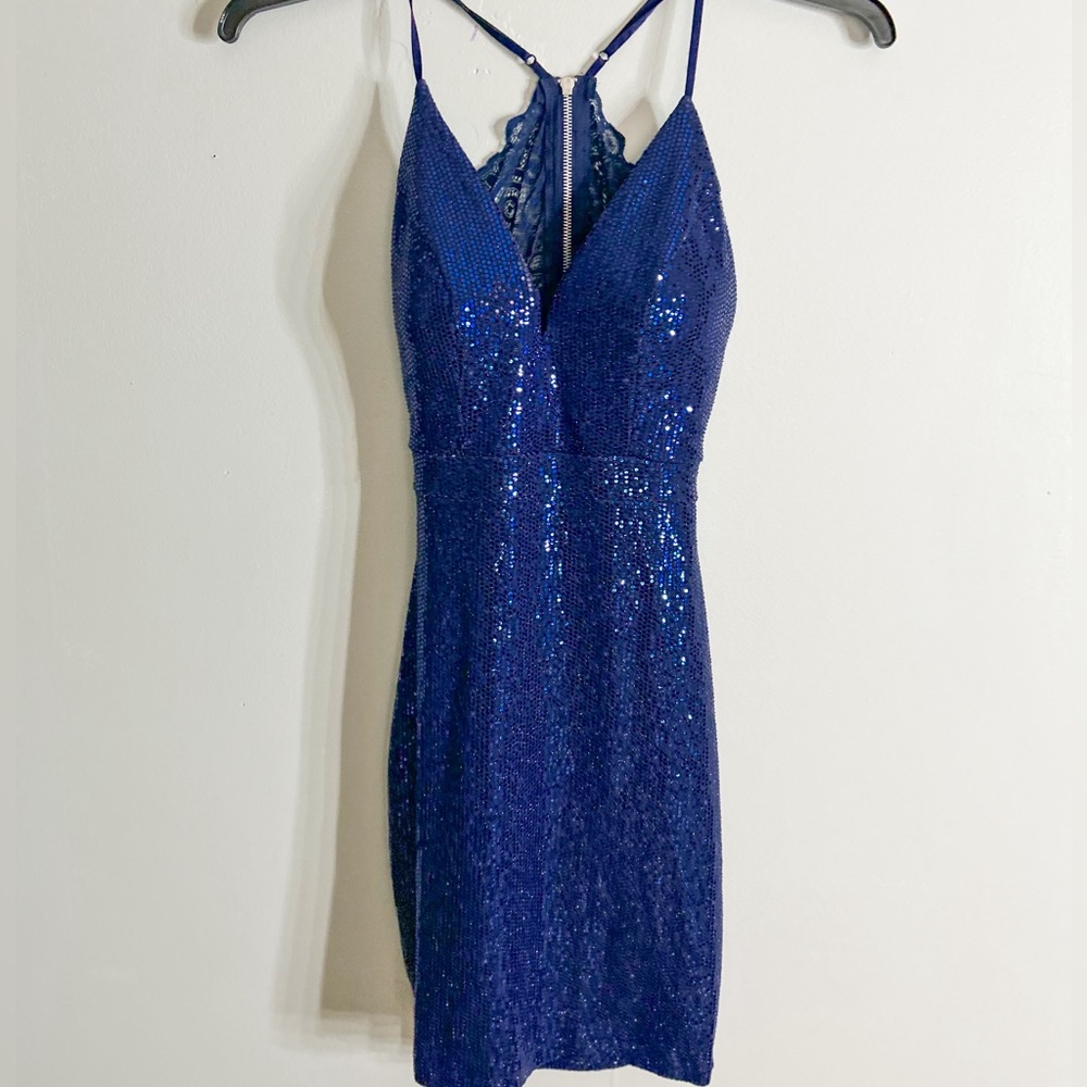 Blue mini dress with sequins and lace and open back.